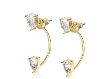 Pair of 18k gold-plated stainless steel Sasha ear jacket earrings featuring pear-shaped clear stones.