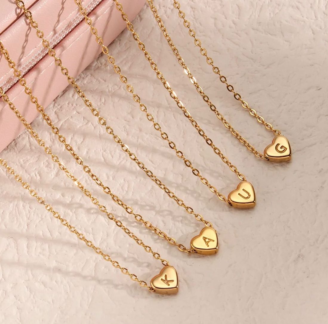 K, A, U and G gold letter medallions